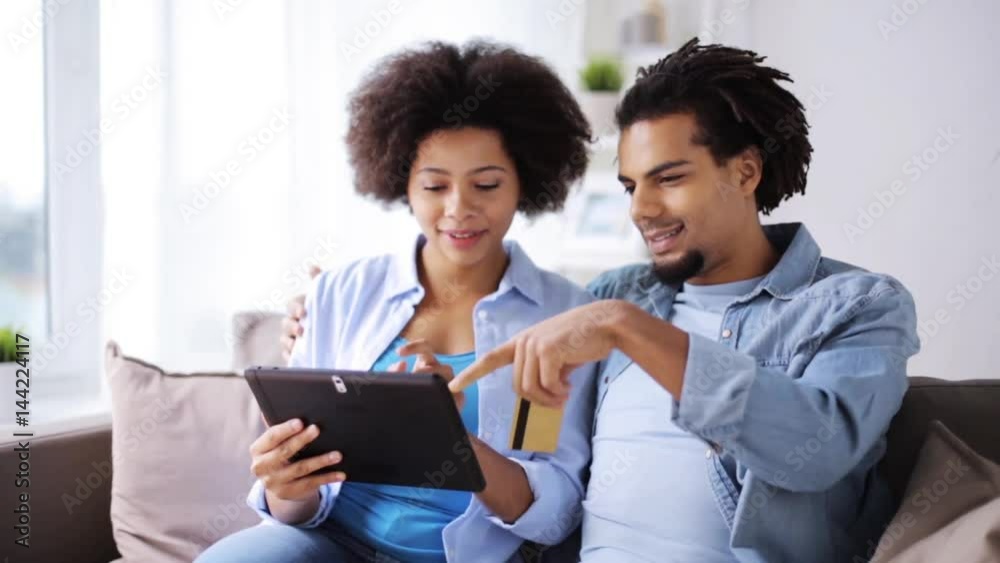 couple with tablet pc and credit card at home couple with tablet pc and credit card at home