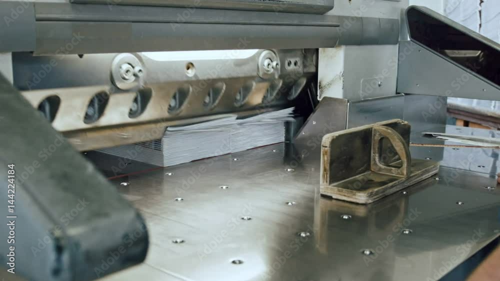 Printing factory - big industrial cutter for cutting paper shears - guillotine machine - close up
