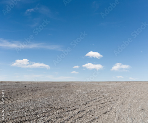 blue sky and gravel ground