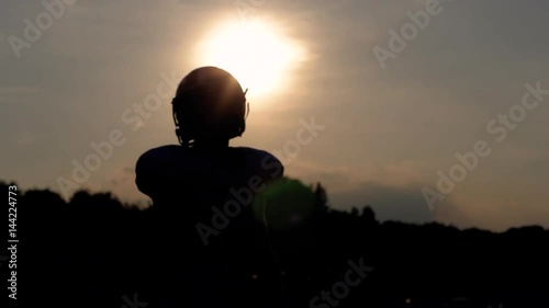 Silhouetted wide receiver warming up during pregame drills