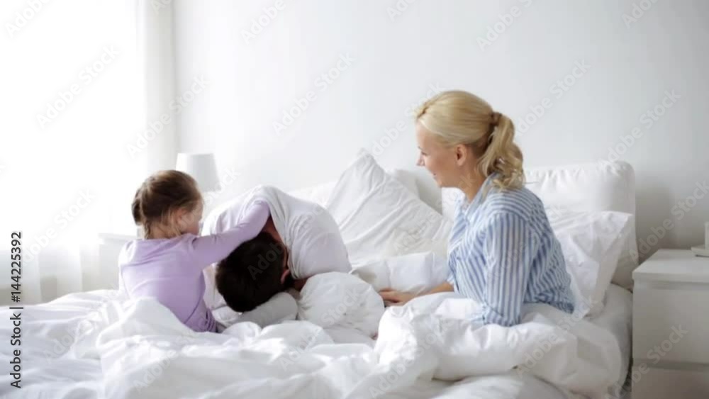 happy family having fun in bed at home happy family having fun in bed at home