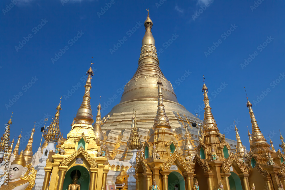 Fototapeta premium Shwedagon Pagoda in daytime with blue sky, the Pagoda is a famous tourist place in Yangon.Myanmar Burma.
