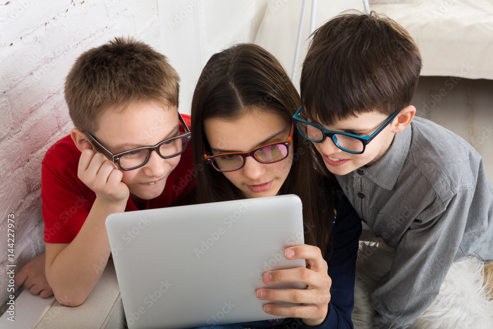 Kids in glasses with tablet, computer addiction Kids in glasses with tablet, computer addiction