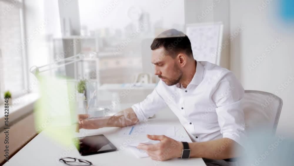 businessman with tablet pc and papers at office businessman with tablet pc and papers at office