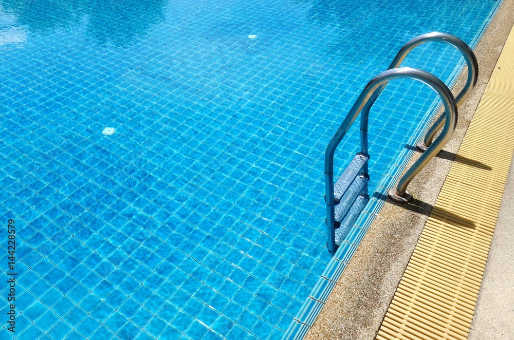 Swimming pool with stair and blue relaxing water