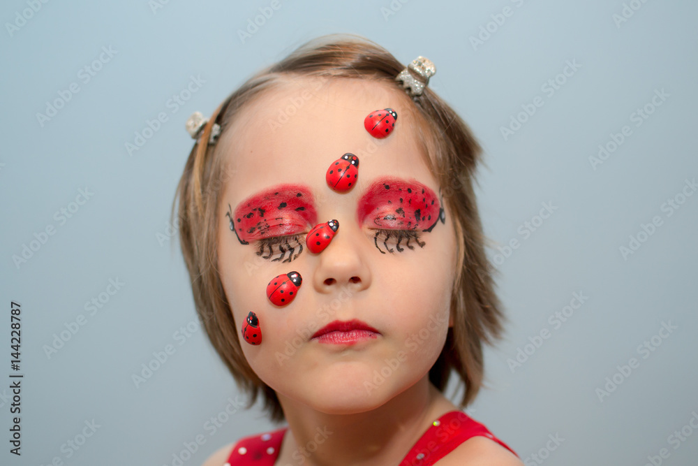 Naklejka premium Little girl with ladybug face paint