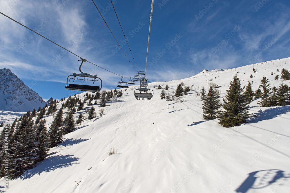 Panoramic view of an alpine mountainside with ski lift Panoramic view of an alpine mountainside with ski lift