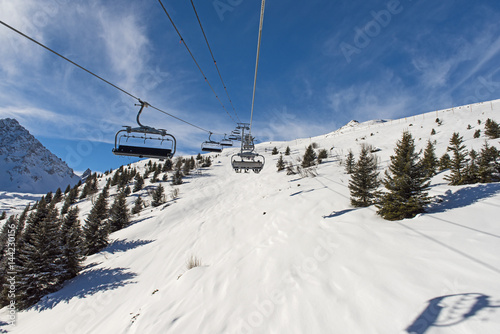Panoramic view of an alpine mountainside with ski lift