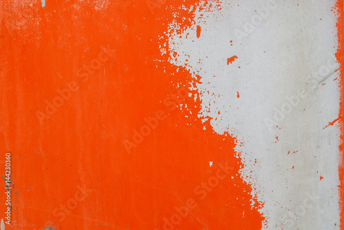 iron surface is covered with orange and grey color remnants of old paint, texture background