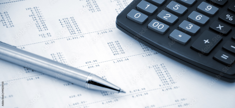 Accounting concept. Pen and calculator on a numbers background Accounting concept. Pen and calculator on a numbers background
