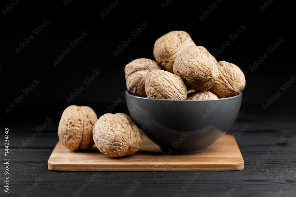 Walnut and walnut kernel on the black background. Walnut and walnut kernel on the black background.