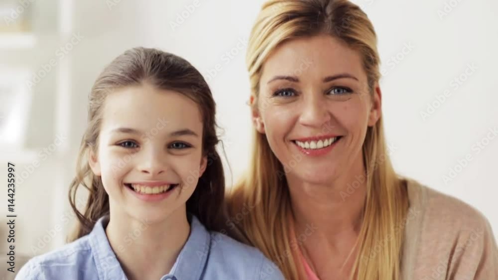 happy smiling mother and girl at home