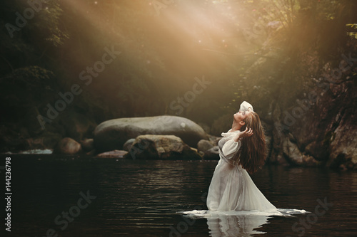 Young woman in fairy pond