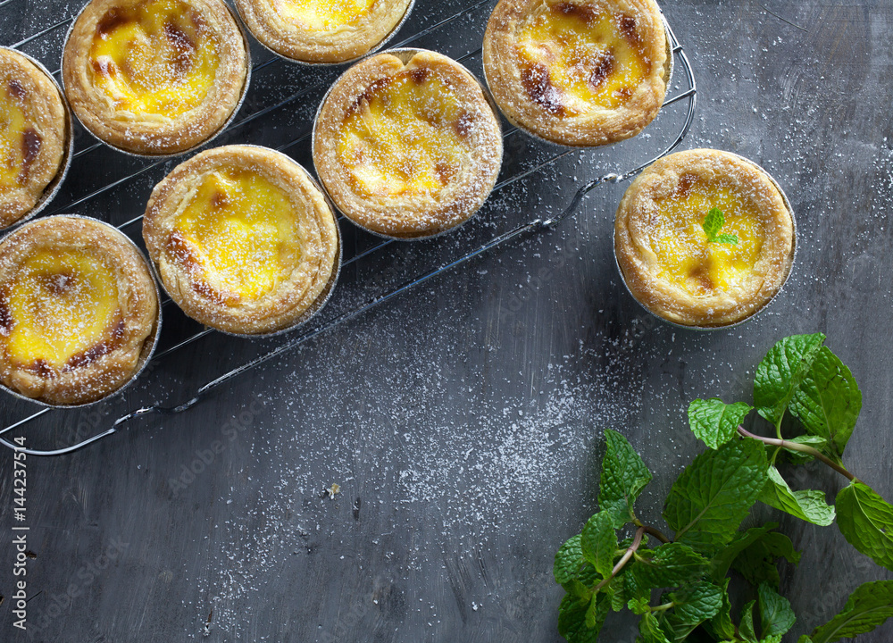 Egg tarts at wooden rustic background Egg tarts at wooden rustic background