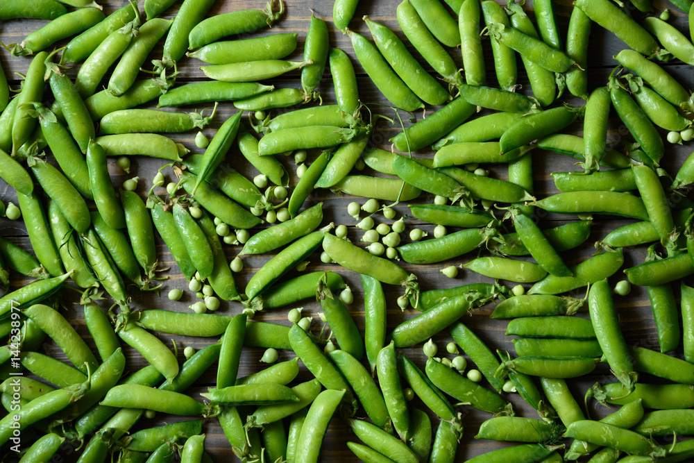 Green food background. Horizontal view. Peas pods pattern Green food background. Horizontal view. Peas pods pattern