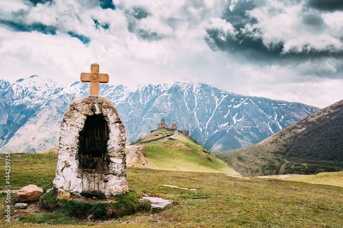 Cross Near Gergeti Trinity Church Or Tsminda Sameba. Holy Trinit photo