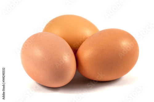Three brown chicken eggs isolated on white