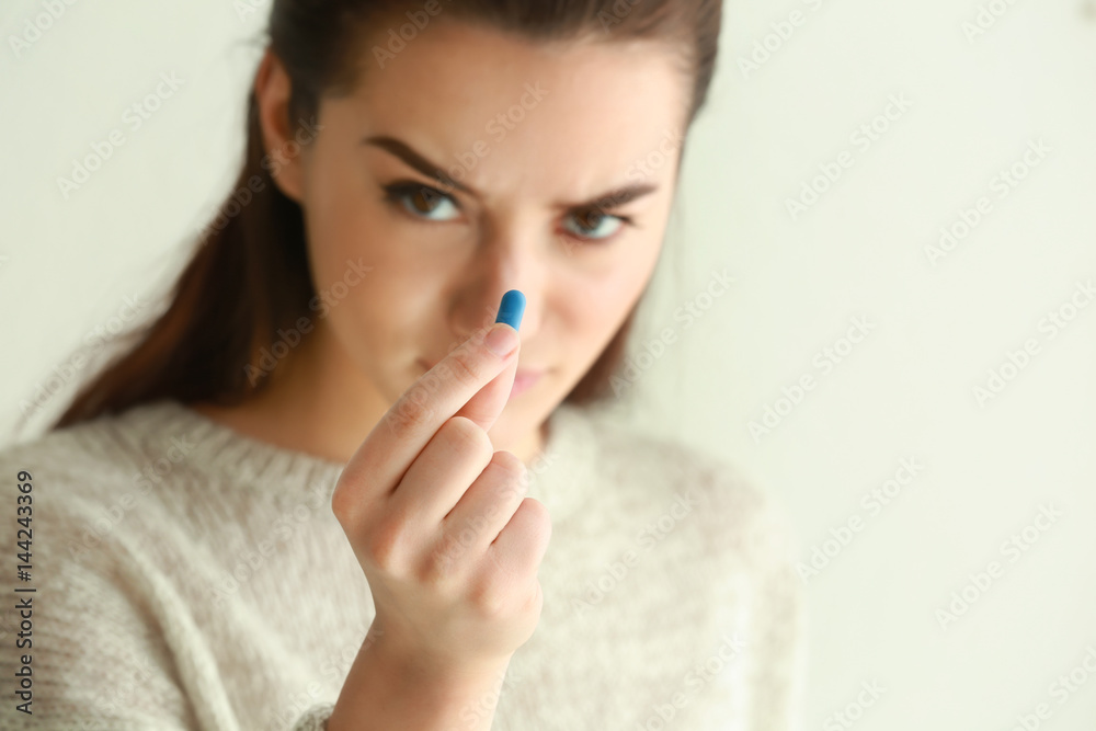 Beautiful young woman with pill at home, closeup Beautiful young woman with pill at home, closeup