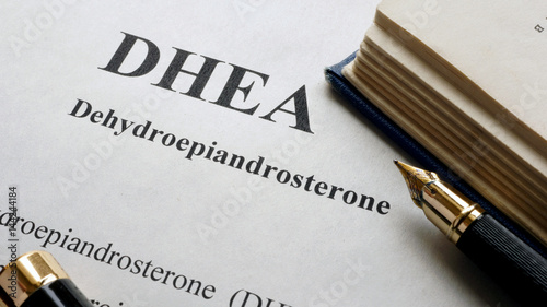 Dehydroepiandrosterone (DHEA) or androstenolone written on a page. Human hormones. photo