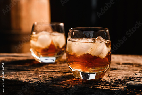 Fototapeta Naklejka Na Ścianę i Meble -  Glass of whiskey on wooden background close up