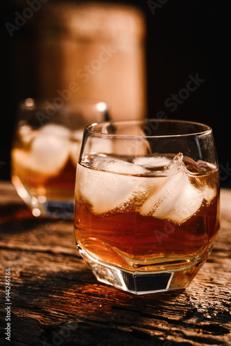 Fototapeta Naklejka Na Ścianę i Meble -  Glass of whiskey on wooden background close up