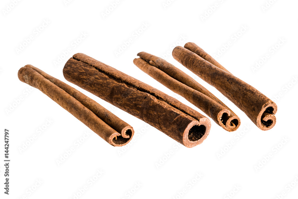 A set of four cinnamon sticks isolated on white background A set of four cinnamon sticks isolated on white background