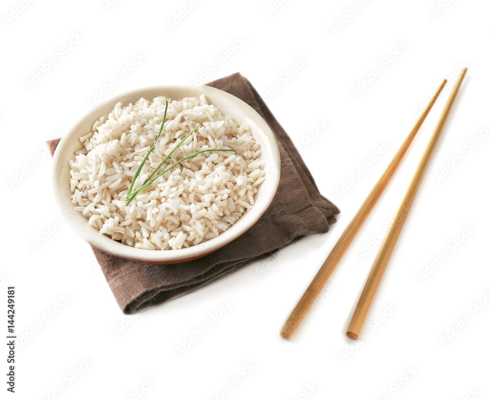 Plate with brown rice on white background