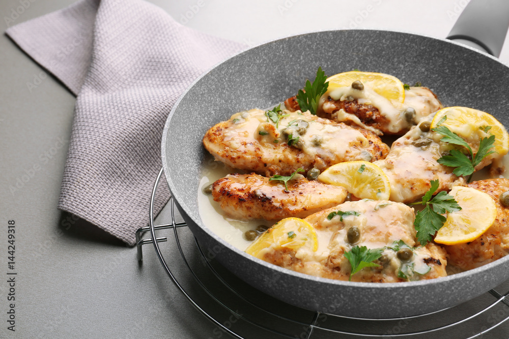 Frying pan with delicious chicken piccata, closeup Frying pan with delicious chicken piccata, closeup