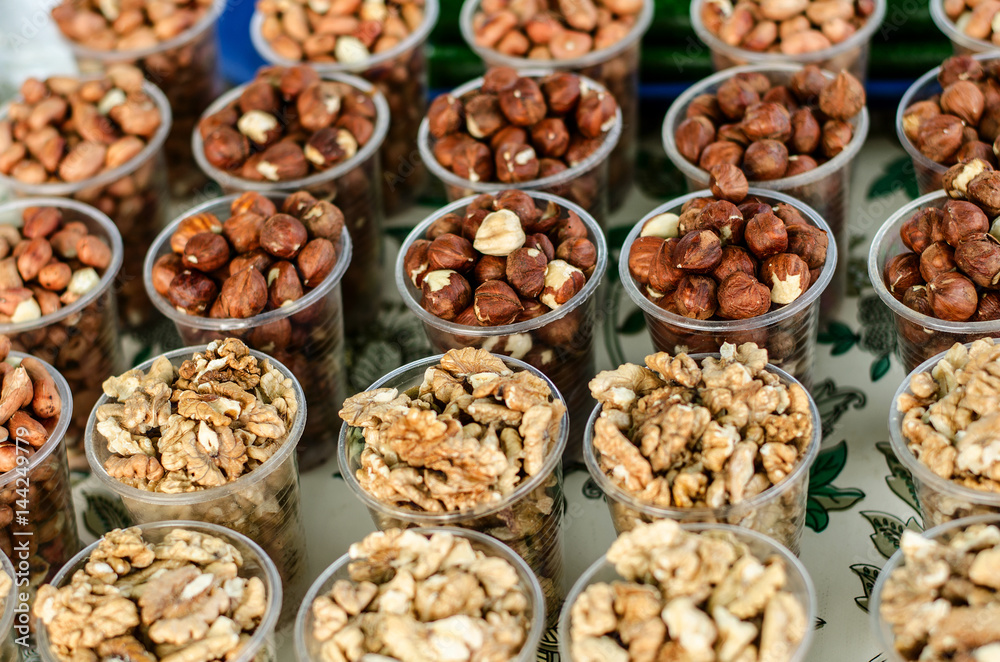 Food background. Different nuts in plastic cups. Food background. Different nuts in plastic cups.