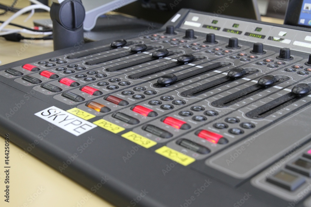 Professional audio operator working on audio mixer knobs during live TV telecast Professional audio operator working on audio mixer knobs during live TV telecast