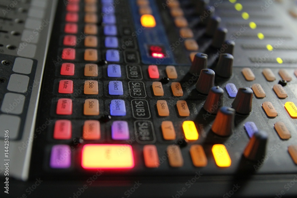 Professional audio operator working on audio mixer knobs during live TV telecast Professional audio operator working on audio mixer knobs during live TV telecast