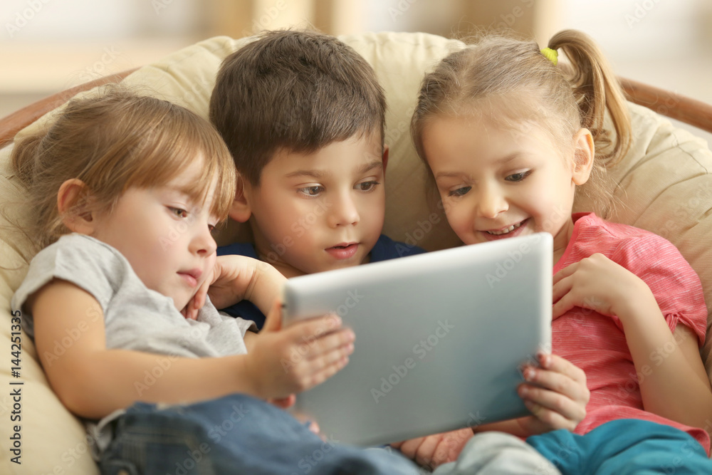 Cute kids using digital tablet Cute kids using digital tablet
