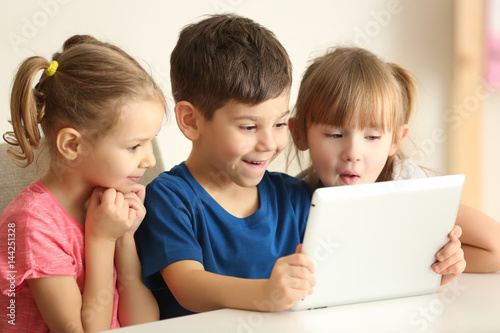 Obraz na płótnie Cute kids using digital tablet