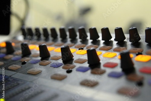 Professional audio operator working on audio mixer knobs during live TV telecast