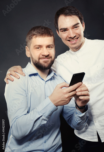 Happy gay couple on black b...