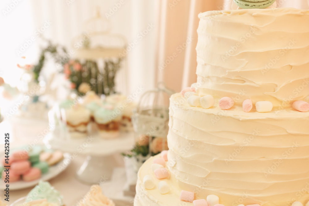 Candy bar. Tasty multi level cake with sweets on table