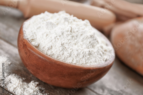 Bowl full of white flour on grey wooden table