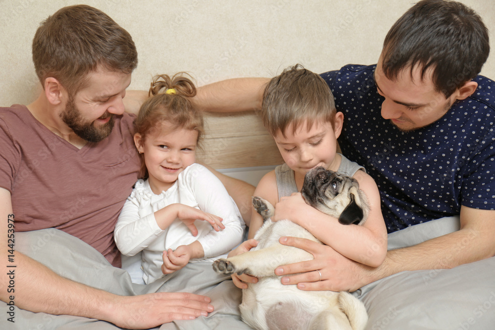 Male gay couple with children resting in bed at home Male gay couple with children resting in bed at home