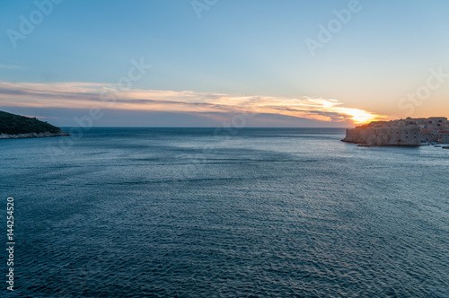 Fototapeta Naklejka Na Ścianę i Meble -  Lokrun island and Dubrovnik connected by a streaking sunset