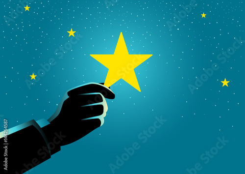 Businessman hand picking up a star