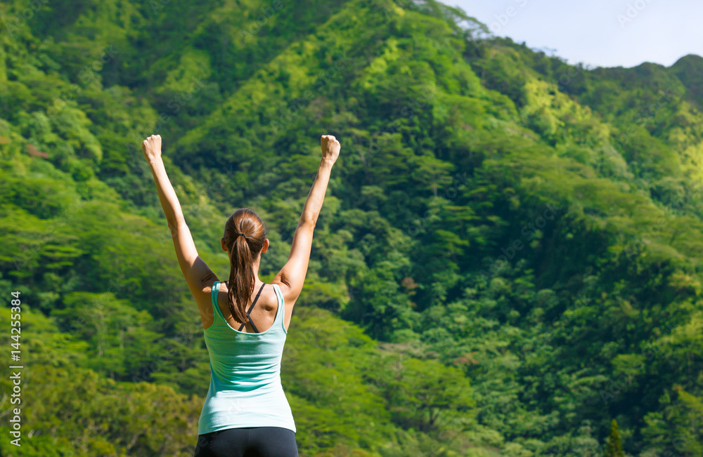 Active healthy lifestyle and fitness goals concept. Fit woman celebrating against a beautiful nature setting. Active healthy lifestyle and fitness goals concept. Fit woman celebrating against a beautiful nature setting.