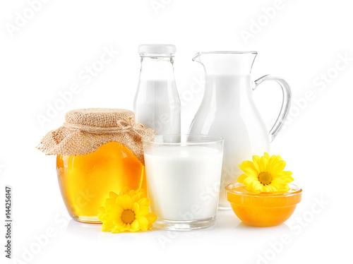 Composition with milk and honey on white background