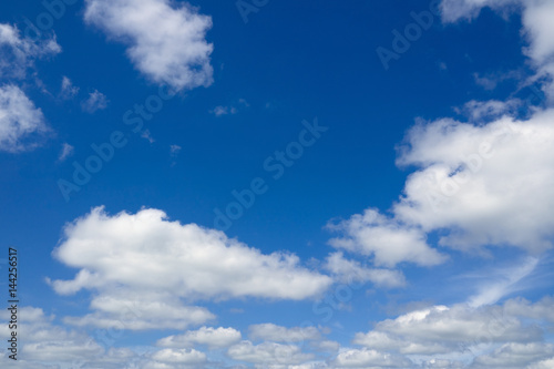 Blue sky with flying clouds over horizon, heaven. White clouds against blue sky.