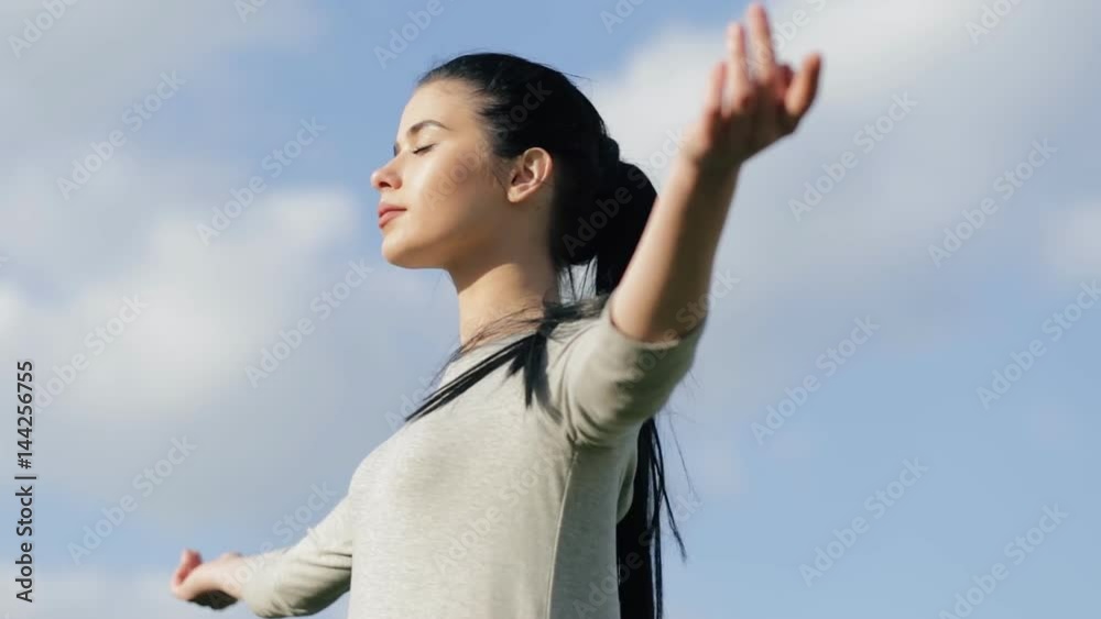 Woman relaxing on a freedom, blue sky background Woman relaxing on a freedom, blue sky background