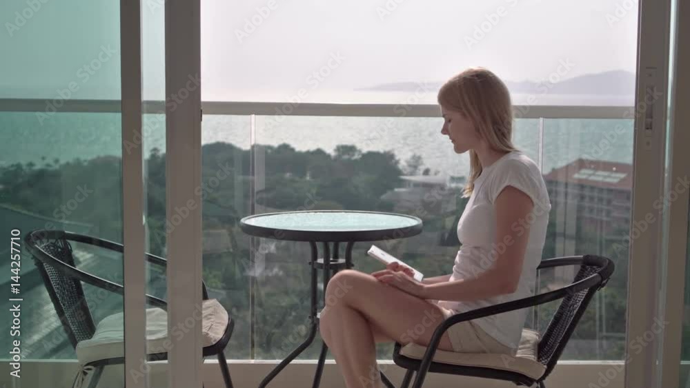 custom made wallpaper toronto digitalBeautiful attractive woman sitting on balcony chair enjoying the view. Stand up and goes inside