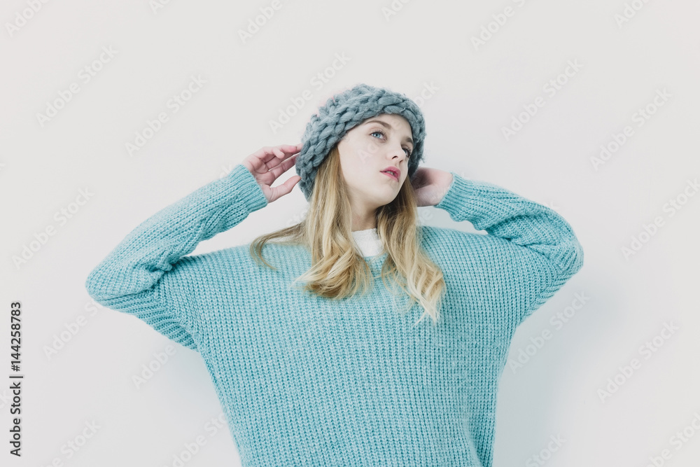 Pretty young girl with blond hair in fashionable sweater, hat Pretty young girl with blond hair in fashionable sweater, hat