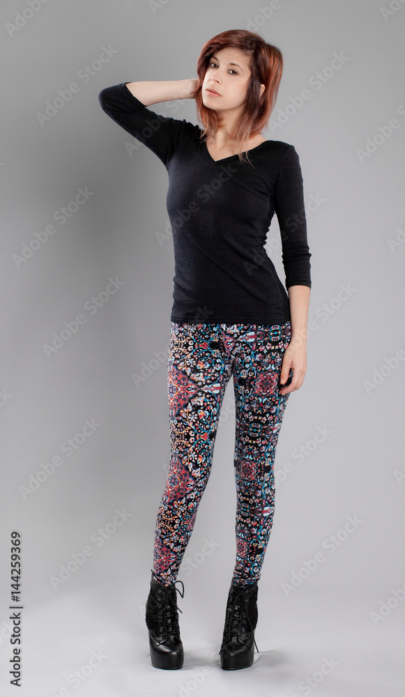 Woman in Black Top, Colorful Patterned Leggings, and High Heeled