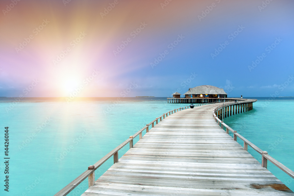 Fototapeta premium The wooden road over the sea to the tropical island