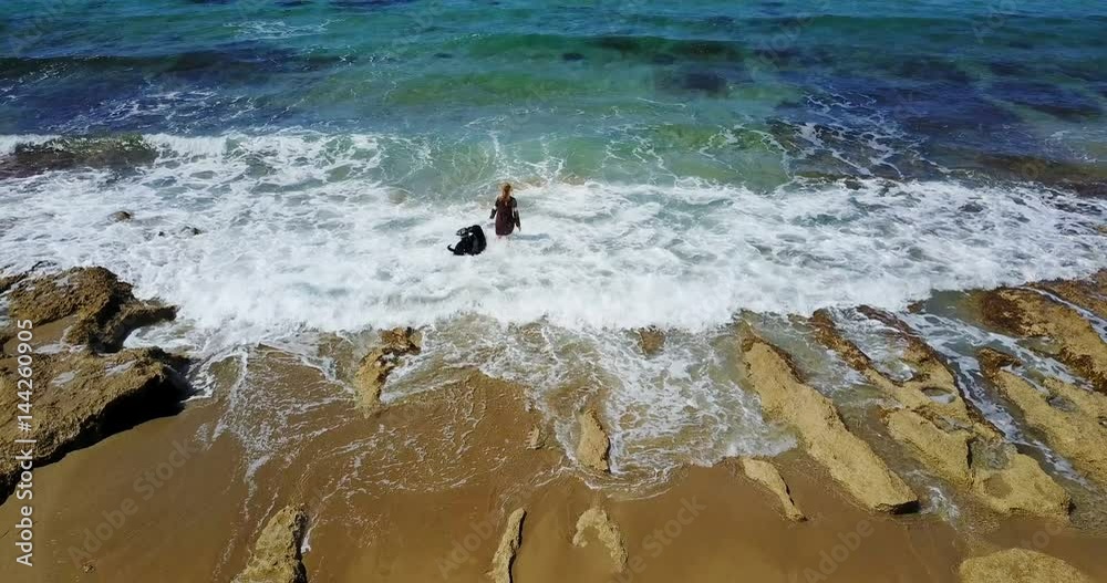 Seascape. Drone Point of View. woman plays with two black big dogs on the beautiful shores of the sea. Mediterranean sea. Cyprus island. Seascape. Drone Point of View. woman plays with two black big dogs on the beautiful shores of the sea. Mediterranean sea. Cyprus island.
