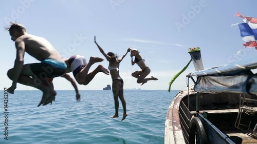 People Jumping In Water From Long Tail Boat, Young Man And Woman Group Of Tourists On Sea In Thailand Slow Motion 120